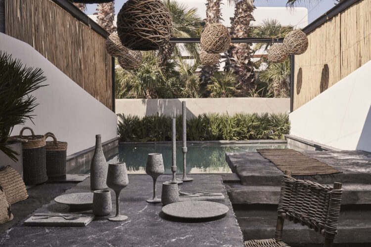 Une petite piscine en forme de L entourée de murs blancs et de plantes, avec une terrasse en pierre brute, à l'hôtel O by Myconian où se trouvent les plus belles piscines de Mykonos
